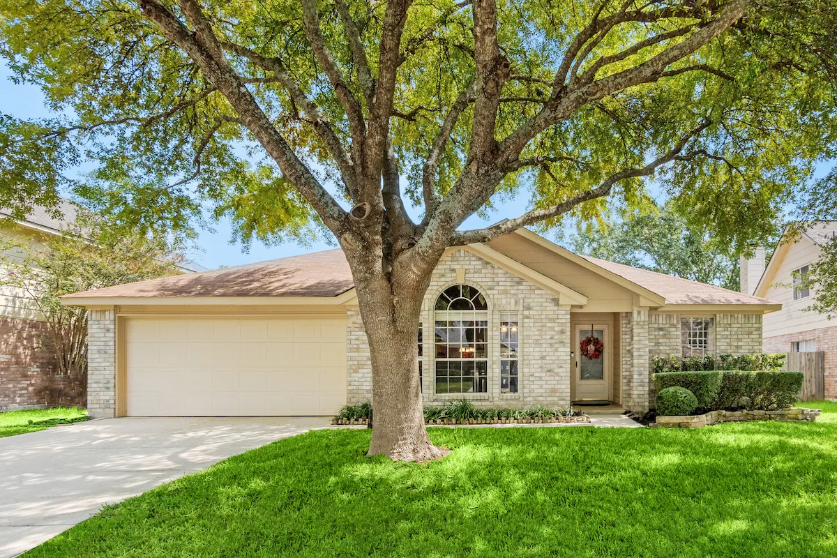 High quality visual content of a rental property, a beautiful house with a stunning tree on the front lawn, illustrating proper marketing strategies that help to increase rental property income.